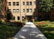 Thumbnail 18 of 19 - a large brick building with a sidewalk in front of it